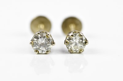 Lot 460 - A pair of diamond ear studs, each claw set...