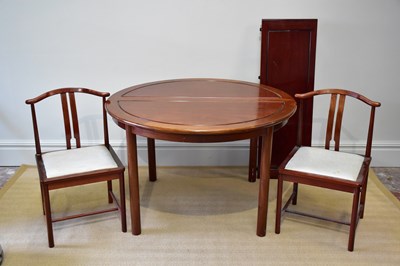 Lot 1109 - A Chinese rosewood dining table with three...