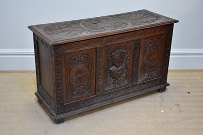 Lot 1182 - A reproduction carved oak coffer of...