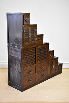 Lot 1117 - A Chinese stained pine cabinet of stepped form...