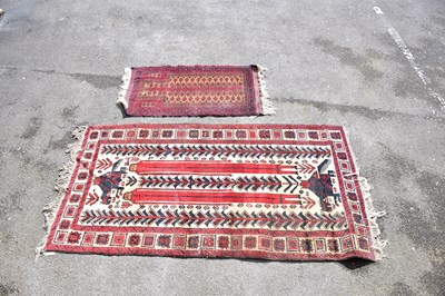 Lot 1210 - An Eastern rug decorated with stylised motifs...