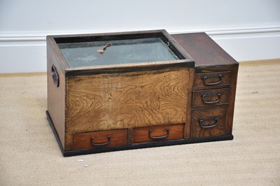 Lot 1121 - A Chinese elm low cabinet with glazed top...