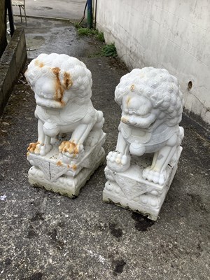 Lot 1219 - A pair of Chinese carved marble models of Shi...