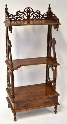 Lot 93 - A mahogany three-tier whatnot, the upper shelf...
