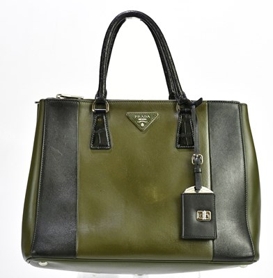 Lot 700 - PRADA; a khaki green and black calfskin...