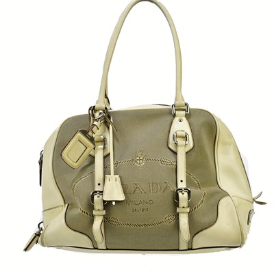 Lot 722 - PRADA; a beige Jacquard canvas logo and cream...