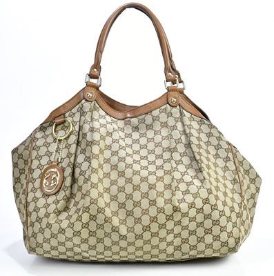 Lot 718 - GUCCI; a brown M M canvas Supreme handbag with...