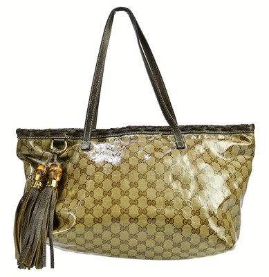 Lot 724 - GUCCI; a patent MM canvas tassel shoulder bag...