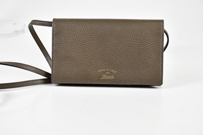 Lot 713 - GUCCI; an unused pebbled brown leather...