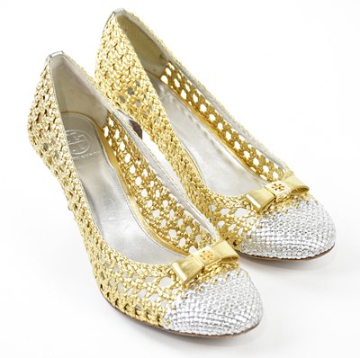 Lot 950 - TORY BURCH; a pair of gold and silver metallic...