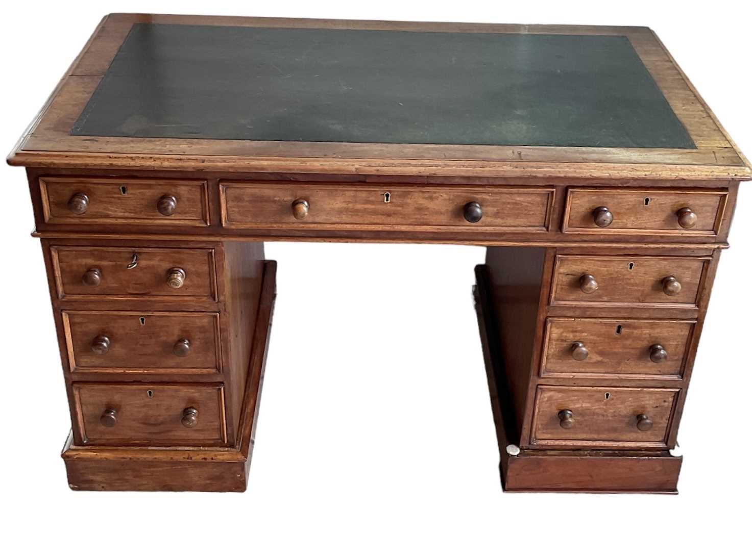 Lot 22 - A Victorian mahogany pedestal desk with black...