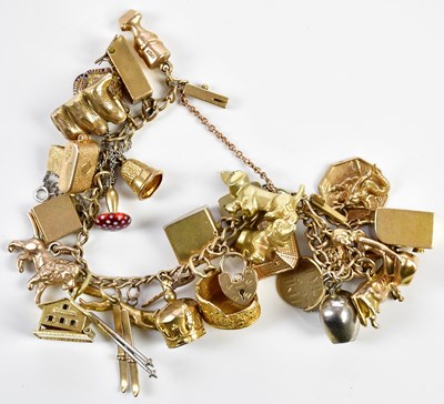 Lot 272 - A yellow metal charm bracelet containing a...