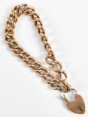 Lot 300 - A 9ct yellow gold curb link bracelet with...