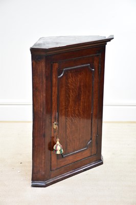 Lot 1197 - An 18th century oak hanging corner cupboard...