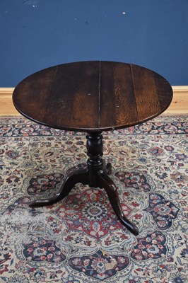 Lot 1188 - An 18th century oak tilt-top tripod table,...