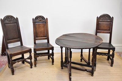 Lot 1186 - An 18th century carved oak drop-leaf dining...