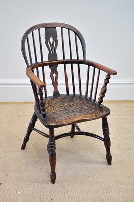 Lot 1176 - A 19th century elm seated hoop back Windsor...