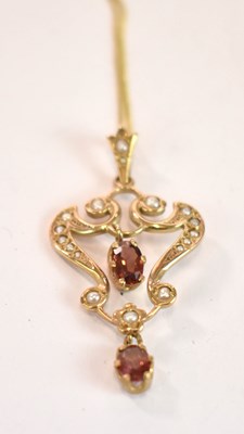 Lot 1202 - A 9ct yellow gold seed pearl set pendant in...