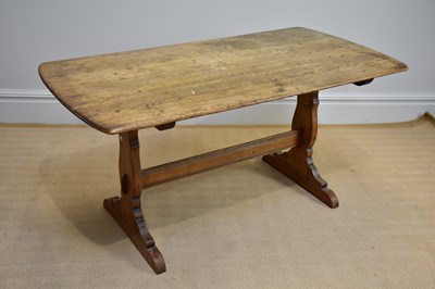 Lot 1159 - A mid century oak dining table, possibly Ercol,...