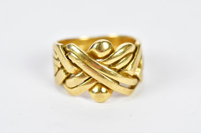 Lot 86 - An 18ct yellow gold puzzle ring, size O,...