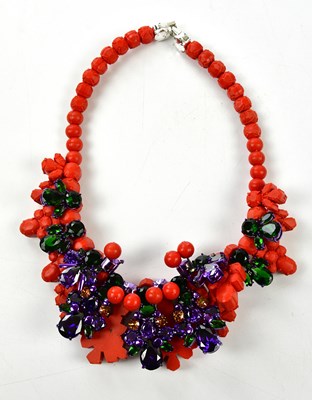 Lot 940 - EK THONGPRASERT; a red silicon choker necklace...