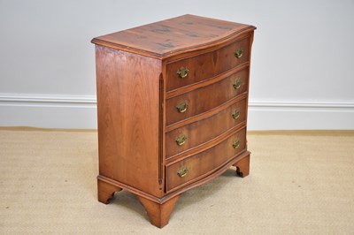 Lot 1137 - A reproduction serpentine fronted yew wood...