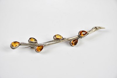 Lot 441 - A white metal foliate brooch, set with citrine...