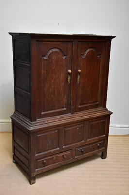 Lot 1170 - An 18th century oak livery cupboard, with two...