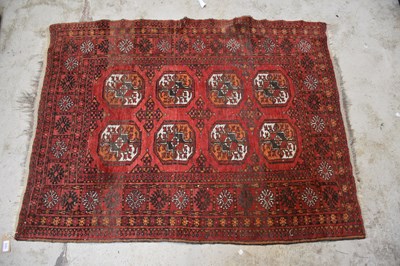 Lot 1215 - A red ground Bokhara style rug with elephant...