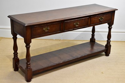 Lot 47 - A 20th century three drawer oak dresser base,...