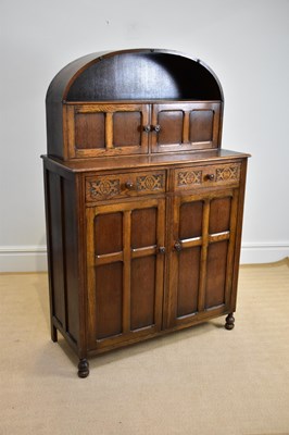 Lot 1133 - A 20th century oak dome top dresser, the...