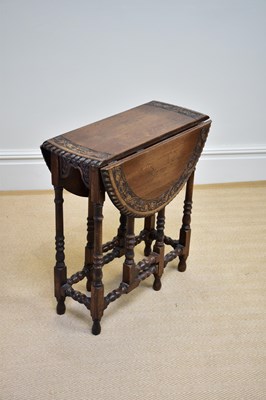 Lot 1136 - A reproduction oak drop-leaf gateleg dining...