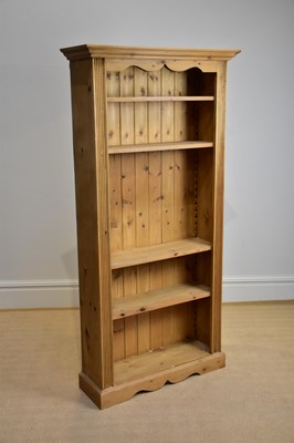 Lot 1145 - A modern pine bookcase with moulded cornice...