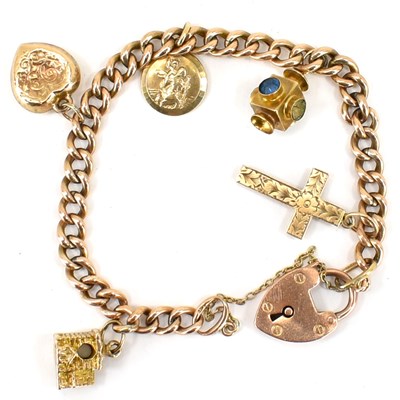 Lot 752 - A 9ct rose gold charm bracelet with five gold...