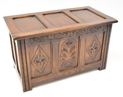 Lot 23 - A small reproduction oak chest with panelled...