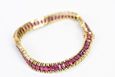 Lot 284 - A 14ct yellow gold ruby set bracelet, length...