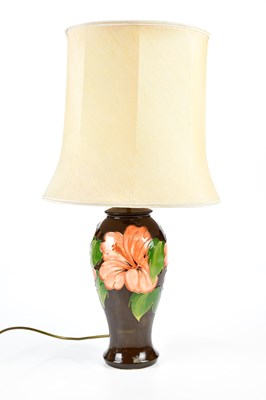 Lot 2774 - MOORCROFT, a 'Hibiscus' pattern table lamp,...