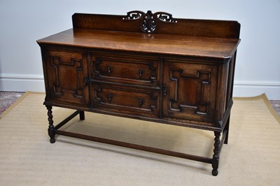 Lot 1181 - A 1920’s Jacobean Revival oak sideboard, with...