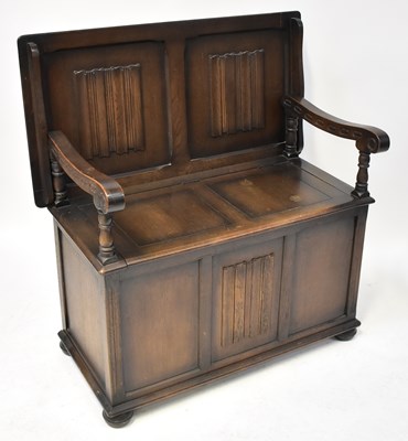 Lot 25 - A reproduction monk's bench with carved...