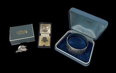 Lot 1542 - A hallmarked silver bangle, Birmingham 1976, a...