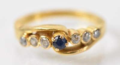Lot 1252 - A yellow metal ring set with central blue...