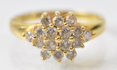 Lot 1253 - A yellow metal cluster ring set with sixteen...