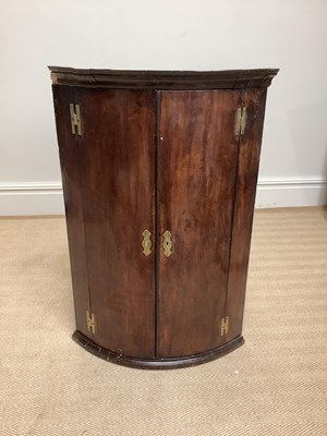 Lot 1073 - A late George III mahogany bowfront hanging...