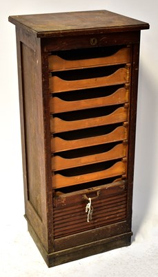 Lot 48 - A 1930s oak tambour-front music cabinet with...