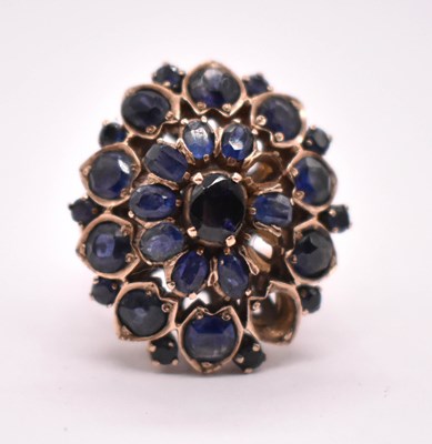 Lot 1184 - A large yellow metal and sapphire floral...