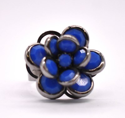 Lot 1185 - An unusual white metal floral ring, the box...