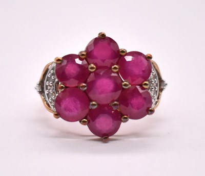 Lot 1178 - A 9ct yellow gold simulated ruby dress ring...