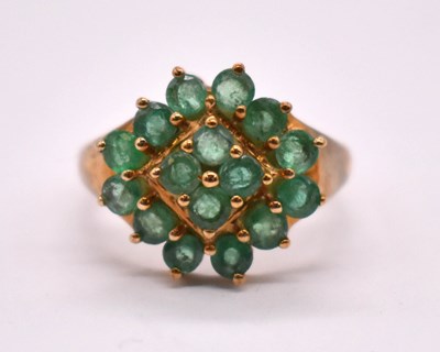 Lot 1179 - A 9ct yellow gold and emerald dress ring with...