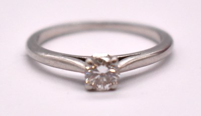 Lot 1176 - CARTIER; a platinum and diamond solitaire ring,...
