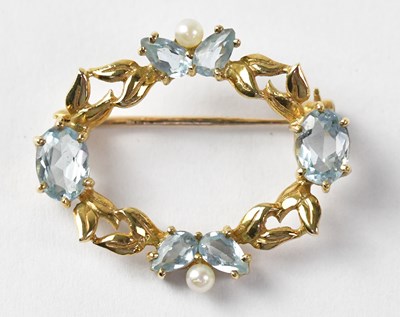 Lot 993 - An oval yellow metal brooch set with...